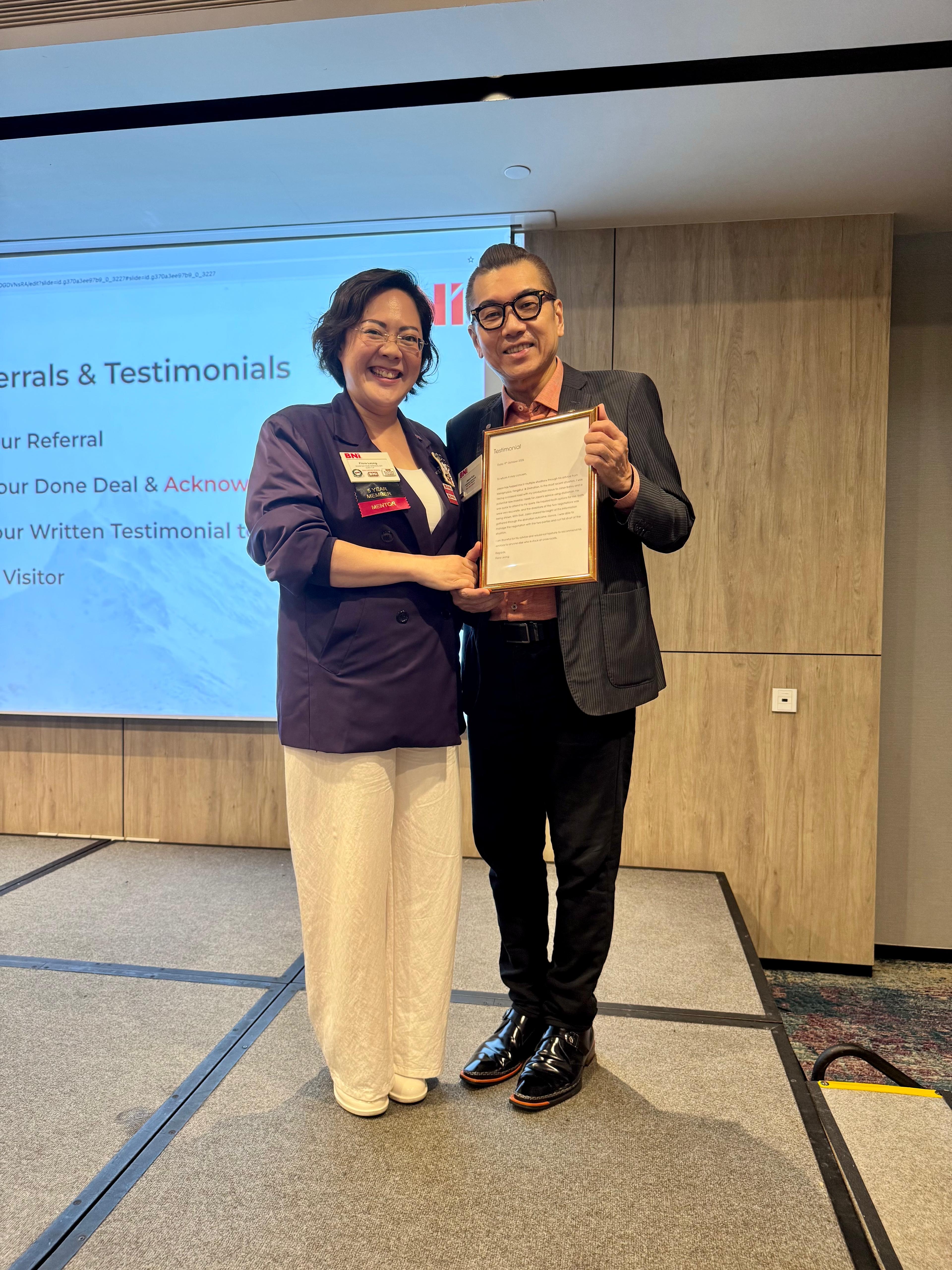 Client Flora sharing testimonials on stage